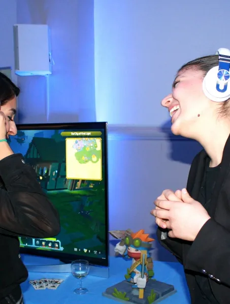 two young females with headphones on enjoying music