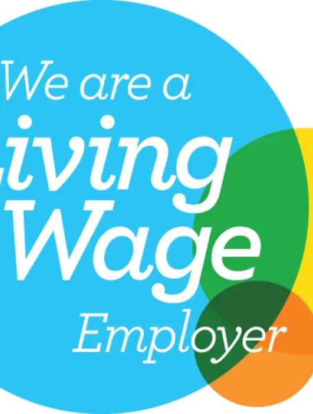 Blue circle with text "We are a Living Wage Employer" in white. Overlapping green, yellow, and orange circles add a sense of positivity and commitment.