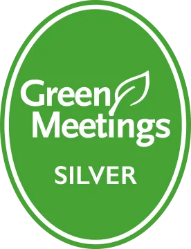 Green oval badge with "Green Meetings" text and a leaf graphic. Below it, "SILVER" is written, indicating an eco-friendly certification level.