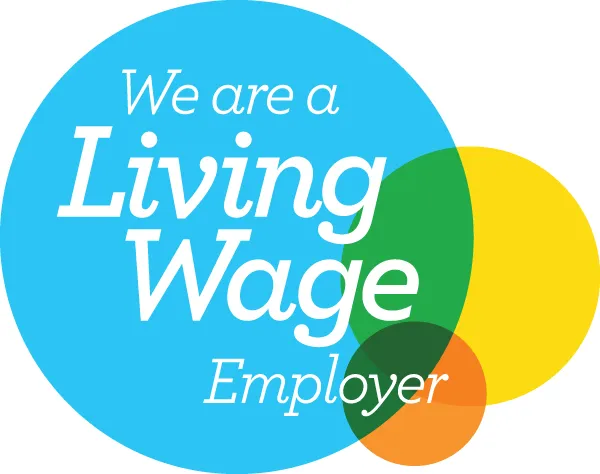 Blue circle with text "We are a Living Wage Employer" in white. Overlapping green, yellow, and orange circles add a sense of positivity and commitment.