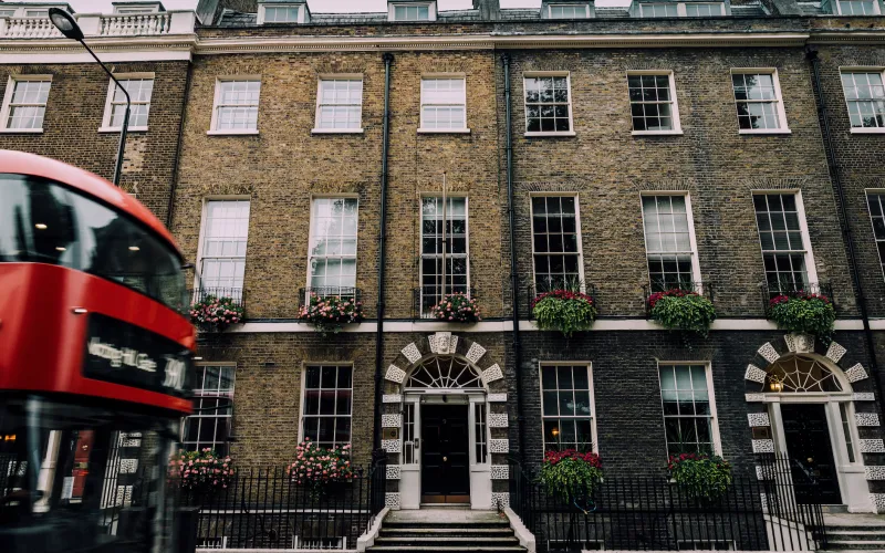 bus driving past a house